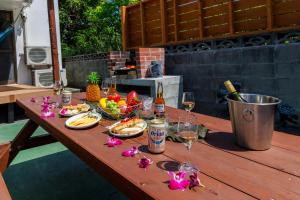 a wooden table with food and wine glasses on it at BANKSHI-SA in Motobu