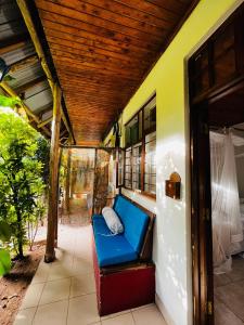 a porch with a blue bench on a house at Triniti Oysterbay in Dar es Salaam +5 photos