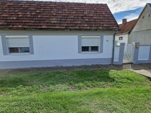 a white house with a red roof at Kuća na dan in Šid