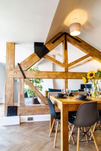 a dining room with a wooden table and chairs at Goodramgate Apartments in York