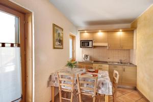 uma cozinha com mesa e cadeiras num quarto em Residence Attila Panorama em Livigno