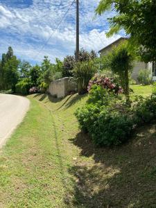 a house with a yard with plants and a road at Domaine Des Deux Rivières in Meilhan-sur-Garonne