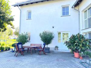 a patio with a table and chairs in front of a house at Ferienwohnung Lilie in Lübbenau