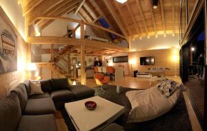 a living room with a couch and a table at Chalet Sno Lodge in Les Deux Alpes