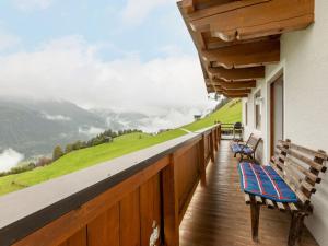 a balcony with a bench and a view of a mountain at Apartment Prieslern - BMG191 by Interhome in Bramberg am Wildkogel