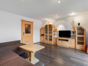 a living room with a couch and a table at Apartment Prieslern - BMG191 by Interhome in Bramberg am Wildkogel