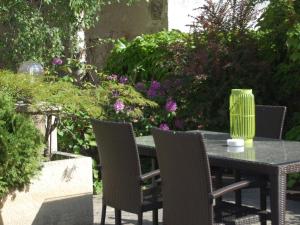 d'une table de patio avec des chaises et un vase. dans l'établissement Apartment Hofgasse - MOE110 by Interhome, à Mörbisch am See