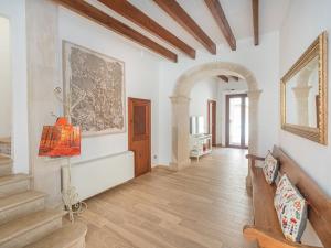een hal met witte muren en houten vloeren en een trap bij Holiday Home Cordella - SNY101 by Interhome in Santanyi