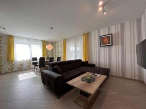 a living room with a couch and a table at Apartment Fuchs-2 by Interhome in Donnerskirchen