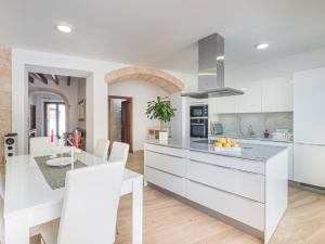 a kitchen with white cabinets and a counter top at Holiday Home Cordella - SNY101 by Interhome in Santanyi