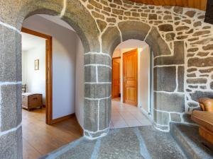 an archway in a room with a stone wall at Holiday Home Maner Penfrat by Interhome in Kerlouan