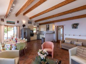 a living room with a table and a kitchen at Holiday Home Maison Balbi by Interhome in Canari +27 photos