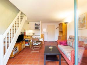 a living room with a couch and a table at Holiday Home Les Olivades by Interhome in Plan-de-la-Tour