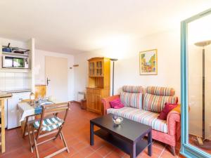 a living room with a couch and a table at Holiday Home Les Olivades by Interhome in Plan-de-la-Tour