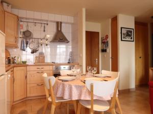 eine Küche mit einem Tisch und Stühlen sowie ein Esszimmer in der Unterkunft Apartment Montfort 9A by Interhome in Nendaz