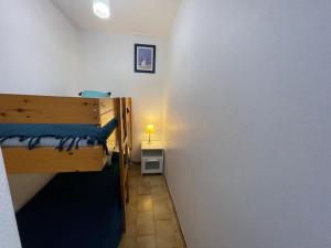 a small room with two bunk beds and a lamp at Apartment Arena-1 by Interhome in La Grande Motte