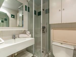 a bathroom with a toilet and a sink and a shower at Apartment Chalet Club-1 by Interhome in Tignes