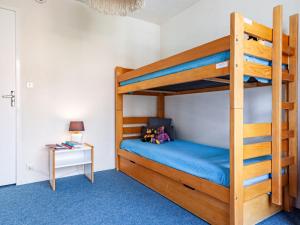 a bedroom with a bunk bed with a blue carpet at Apartment Lunik Orion-17 by Interhome in Le Corbier