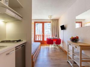 a kitchen and a living room with a bed and a table at Apartment Chalet Club-4 by Interhome in Tignes