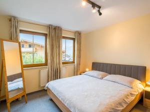 a bedroom with a large bed and a window at Apartment Haus Kitzsteinhorn by Interhome in Zell am See