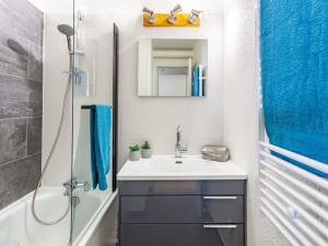 a bathroom with a sink and a shower at Apartment Lunik Orion-18 by Interhome in Le Corbier