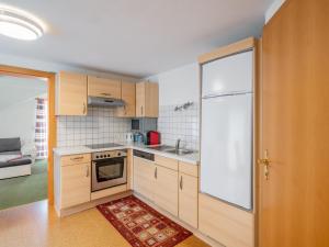 a small kitchen with a sink and a stove at Apartment Haus Toferer by Interhome in Grossarl
