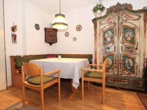 a dining room with a table and a large cabinet at Apartment Am Birkenhain-29 by Interhome in Seefeld in Tirol