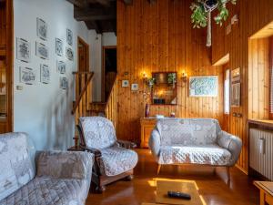 a living room with two chairs and a couch at Chalet Sanitate by Interhome in Leverogne Rochefort