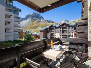 a table on a balcony with a view of a mountain at Apartment Le Pramecou-11 by Interhome in Tignes