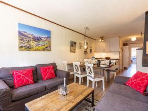 a living room with a couch and a table at Apartment Le Pramecou-11 by Interhome in Tignes