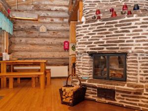 ein Wohnzimmer mit einem Steinkamin und einem Tisch in der Unterkunft Holiday Home Villihanhi 7b by Interhome in Nissi