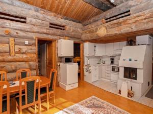 a kitchen and dining room with a table in a cabin at Holiday Home Rukanlumous 1 by Interhome in Ruka