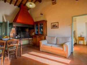 a living room with a couch and a table and a kitchen at Apartment Campiglia-1 by Interhome in Tavarnelle in Val di Pesa