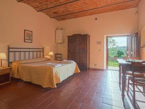 a bedroom with a bed and a table and a window at Apartment Campiglia-3 by Interhome in Tavarnelle in Val di Pesa