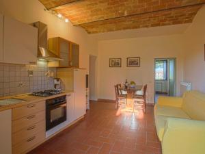 a kitchen with a couch and a table in a room at Apartment Campiglia-3 by Interhome in Tavarnelle in Val di Pesa