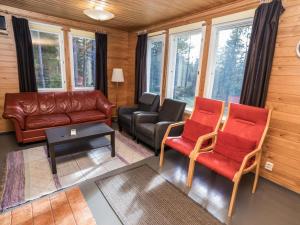 a living room with a leather couch and chairs at Holiday Home Rintelä 5a by Interhome in Ruka