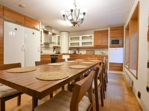 a large kitchen with a wooden table and chairs at Holiday Home Villa ekdal by Interhome in Kustavi