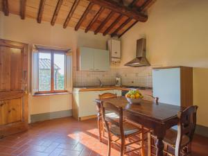 a kitchen with a wooden table with a bowl of fruit on it at Apartment Camiglia by Interhome in Tavarnelle Val di Pesa