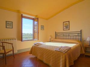 a bedroom with a bed and a window at Apartment Camiglia by Interhome in Tavarnelle in Val di Pesa