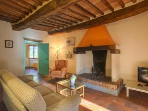 a living room with a fireplace and a couch at Apartment Campiglia-5 by Interhome in Tavarnelle in Val di Pesa