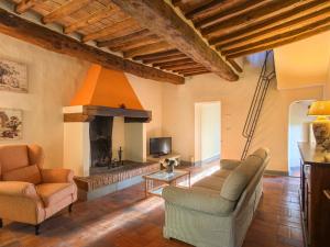 a living room with two chairs and a fireplace at Apartment Campiglia-5 by Interhome in Tavarnelle in Val di Pesa