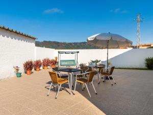 a patio with a table and chairs and an umbrella at Holiday Home Marta - ESP110 by Interhome in Esposende
