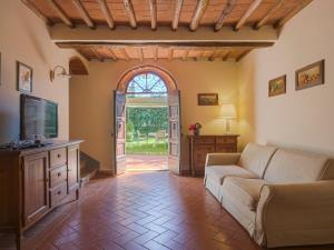 a living room with a couch and a tv at Holiday Home Campiglia-6 by Interhome in Tavarnelle in Val di Pesa