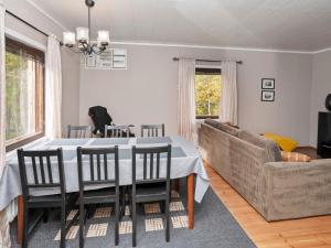 a dining room with a table and a couch at Holiday Home Vuorimäki by Interhome in Ruka