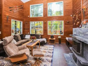 a living room with a couch and a fireplace at Holiday Home Arctic chalet by Interhome in Ylläsjärvi