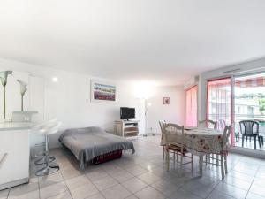 a bedroom with a bed and a table and a kitchen at Apartment Côté Port by Interhome in Cavalaire-sur-Mer +19 photos