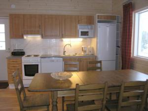 una cucina con un tavolo e un frigorifero bianco di Holiday Home Pernoo 2 by Interhome a Pernoo Altre 14 foto