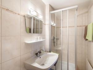 a white bathroom with a sink and a shower at Apartment Fürstauer by Interhome in Saalfelden am Steinernen Meer