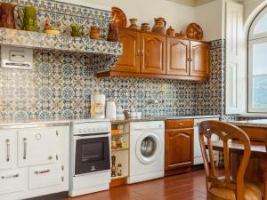 a kitchen with a washing machine and a dishwasher at Holiday Home De Ferreira - PDE105 by Interhome in Ponte de Lima