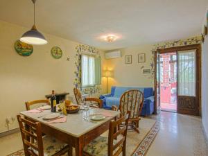 a dining room with a table and chairs and a couch at Holiday Home Borgo della Limonaia-4 by Interhome in Pieve a Nievole